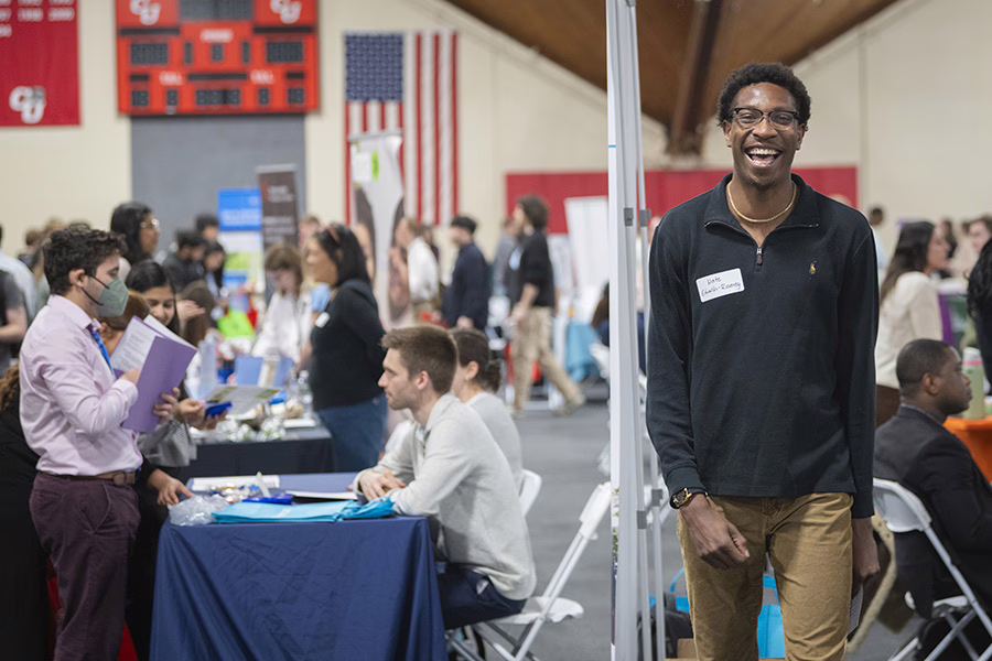 happy student walking away from career fair table
