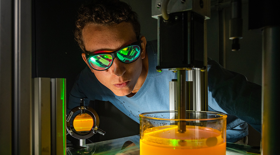 physics student looking over specimen