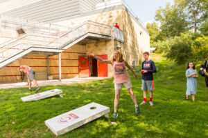 family playing cornhole