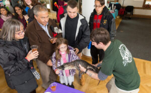 family handling small alligator