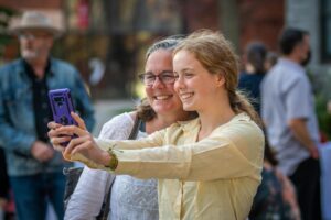 daughter taking picture with mom