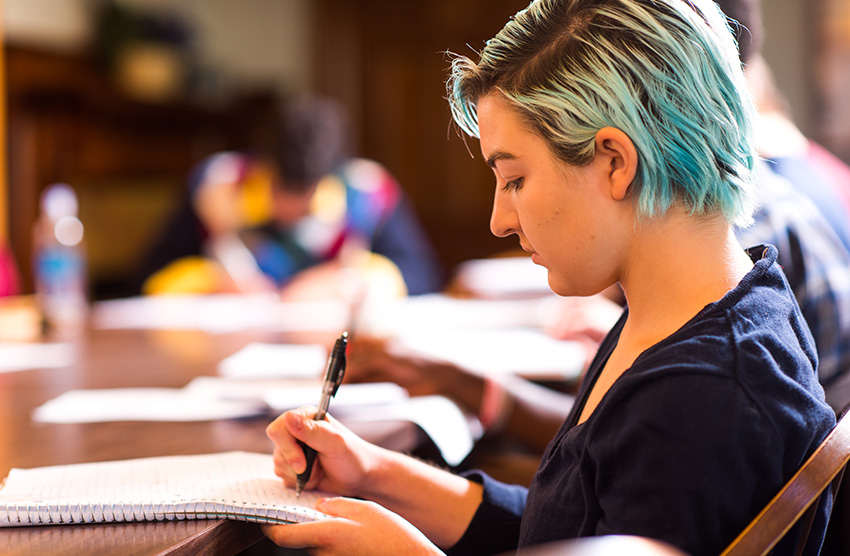 Student writing in notebook