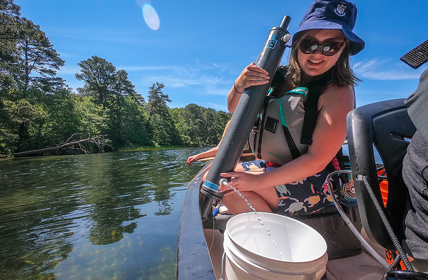 Undergraduate student testing water in Cape Cod