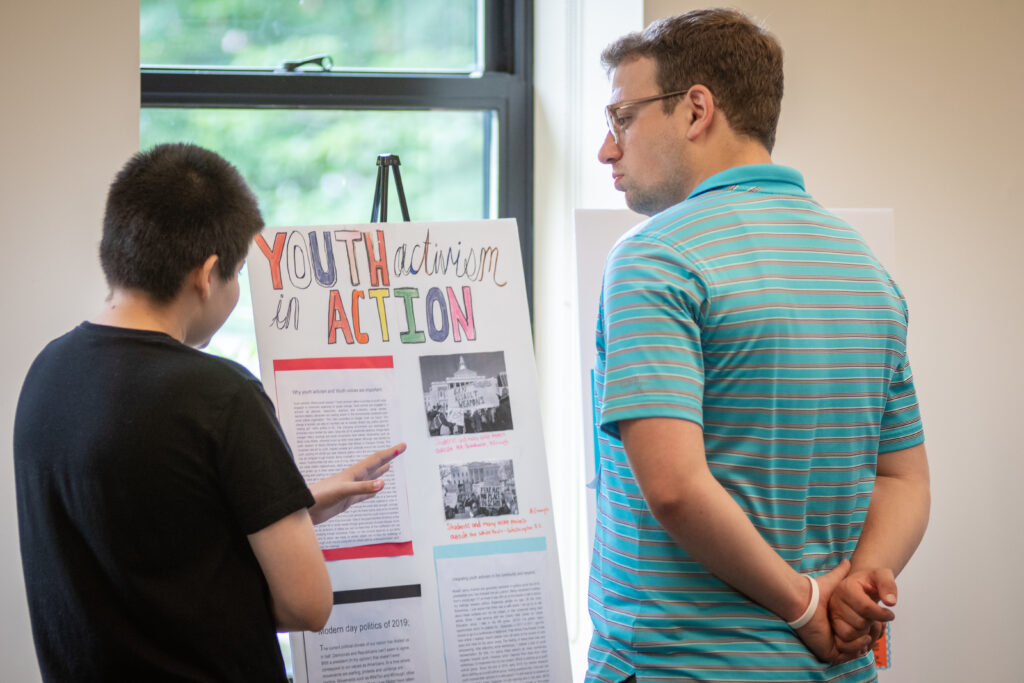 youth showing off poster board