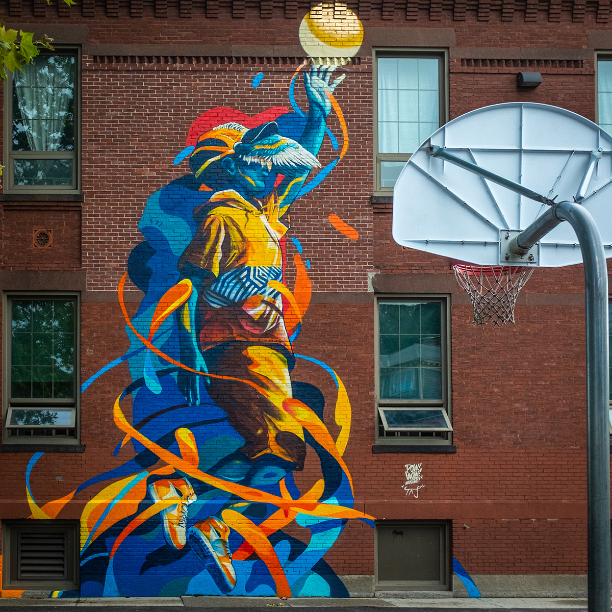 wall mural on building with basketball hoop