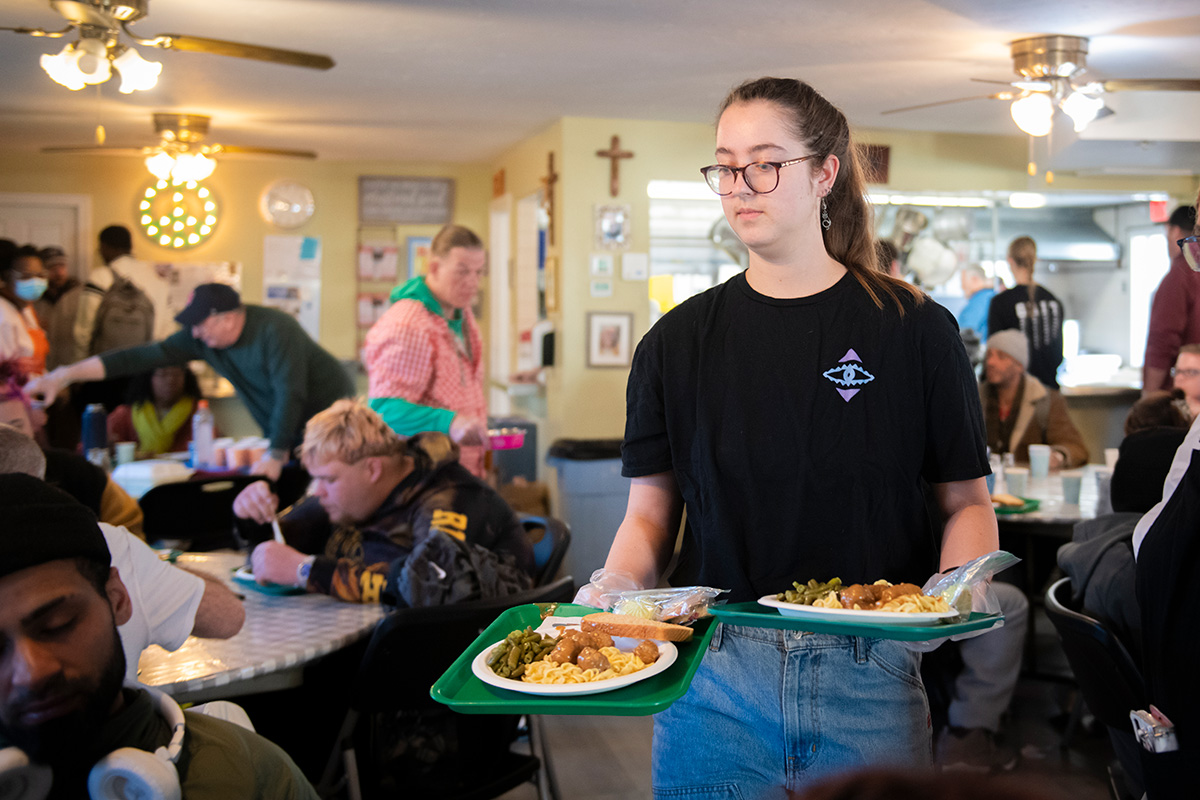 students working in the community feeding the homeless
