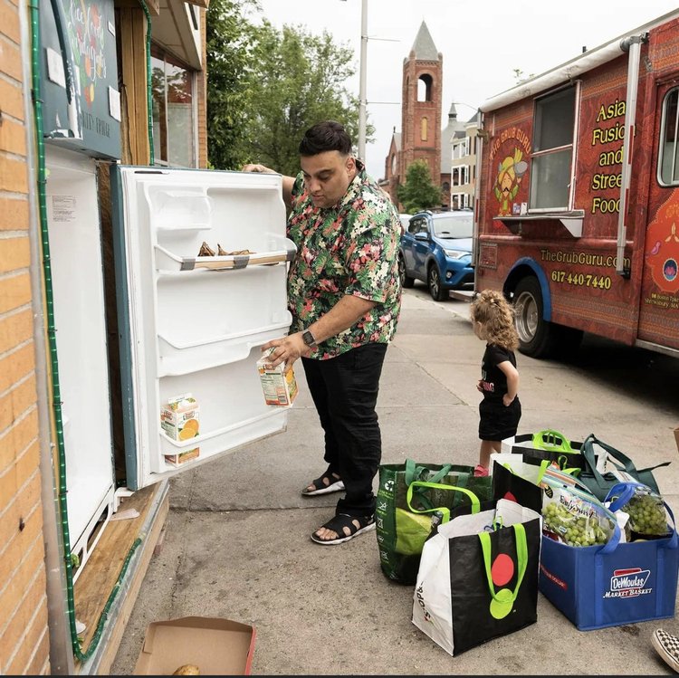 person getting food from refrigerator